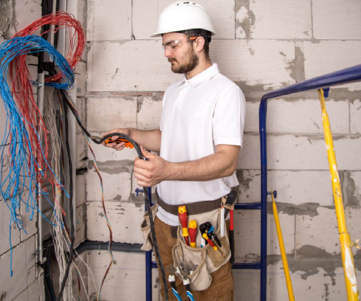 electrician-working-near-board-with-wires-installation-connection-electrics